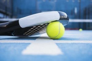 Tennis racquet on blue court