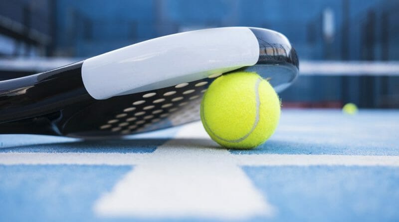 Tennis racquet on blue court